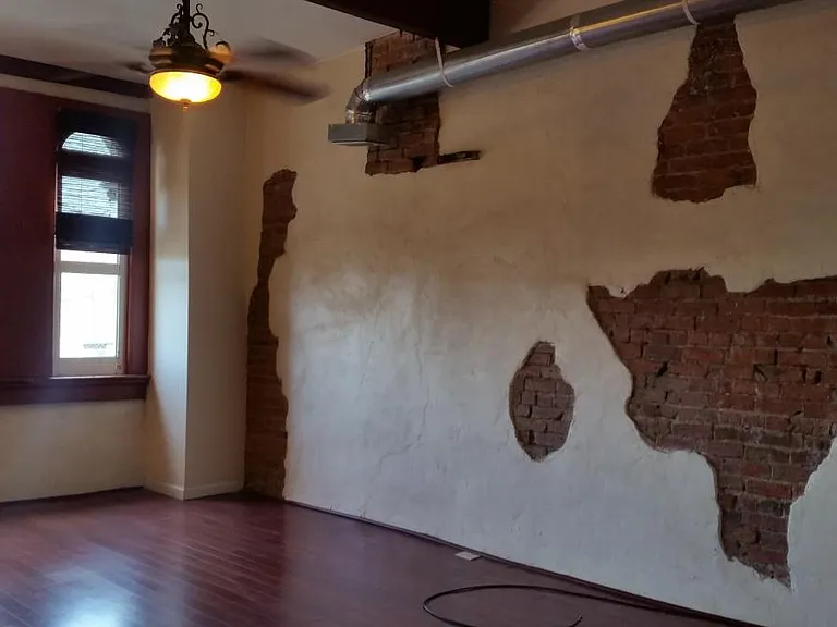Large French Quarter Exposed Brick wall throughout the condo