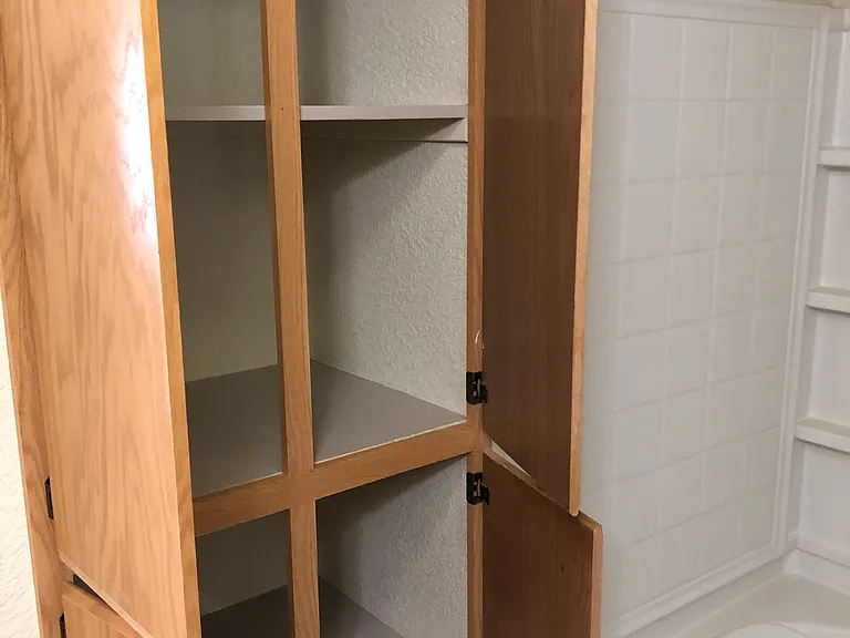 Master bath has plenty of storage cabinets.