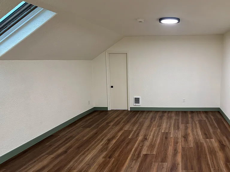 Full living room area. Utility door (locked) for contractor access to attic vents and fans.