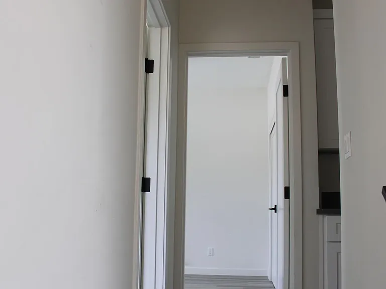 on top of steps leading to the second floor you see two of extra bedrooms