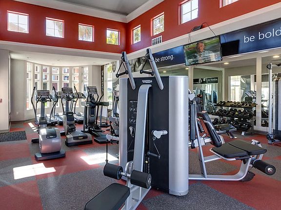Fitness center with cardio and strength training equipment.