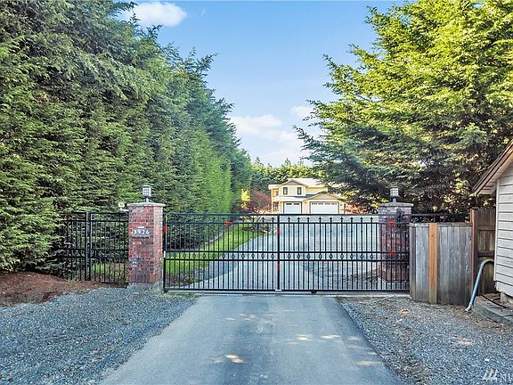 The majority of this one acre lot is fully fenced - here is the entrance with a very nice wrought iron gate.  