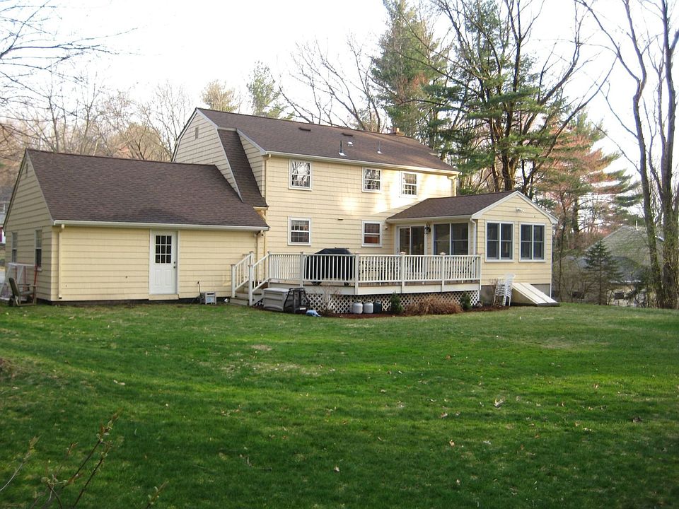 Large mahogany deck overlooks lovely manicured grounds on near acre!