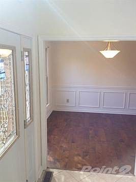 Beautiful new front door with side lights, view into formal dining room. Entry has new ceramic tile