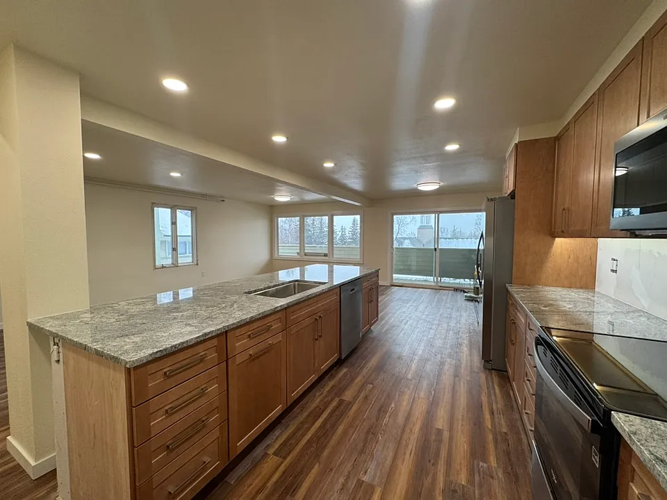 Open concept Kitchen, Dining and Living Room. South and West facing provides a ton of light. Direct access to private deck and stairs to the garden.