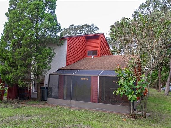Rear view of townhouse with screened enclosed lanai