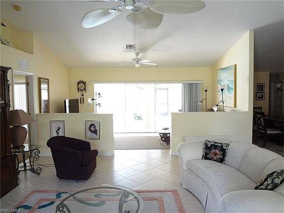 Living room looking toward TV area and patio sliders.