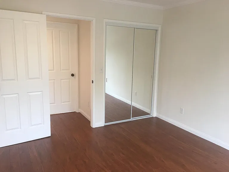 Bedroom to hallway showcasing closet