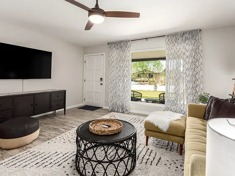 Large Smart TV and cozy seating overlooking the front yard & putting green