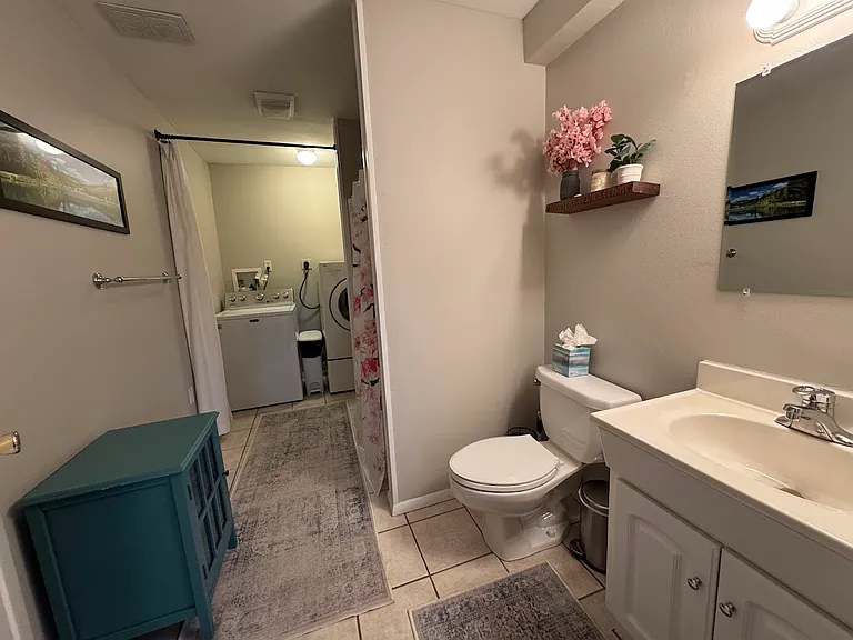 basement level 3/4 bathroom with laundry