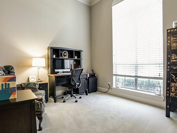 Upon entering the home to the right is a generous living space to be used as a home office, study, or living area with lots of natural lighting.