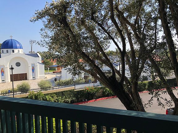 First floor unit nestled in quiet corner with View of the Greek Orthodox Church from balcony.