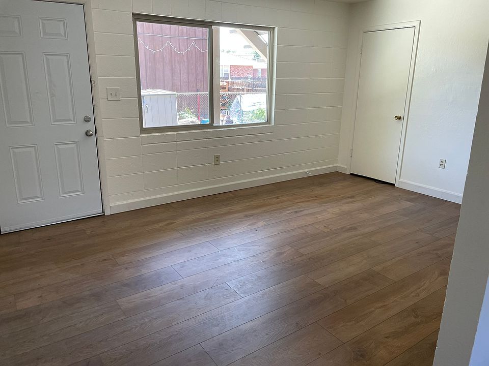 Living room view from kitchen. Note storage closet on right.