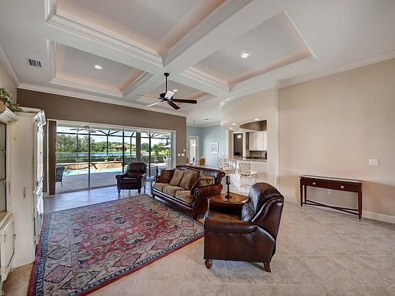 The Great Room ~ Coffered Backlit Ceilings, Tile Set on The Diagonal, Crown Molding, Tall BaseBoards, 4 Window Slider Pockets an