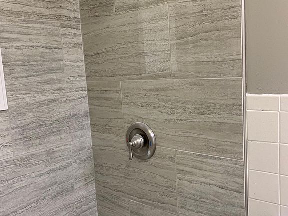 New tub and tile shower in bathroom