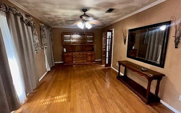 Hallway featuring light hardwood / wood-style floors and ornamental molding