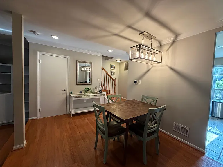 Same living room area, now with new paint, crown molding, and some furniture