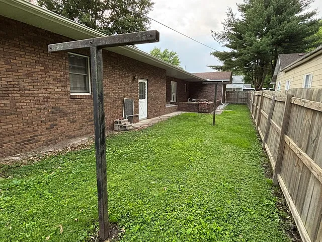 Backyard clothesline and garage door entrance.