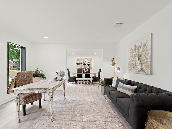 Formal living / flex space with oversized windows to the front of the house.