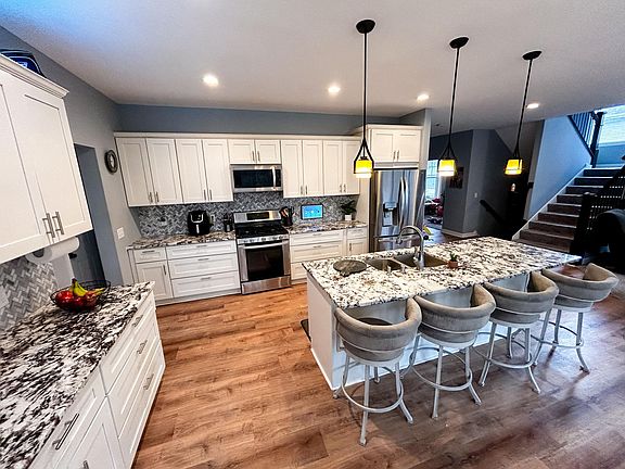 Kitchen with stainless appliances and granite counters on the breakfast bar