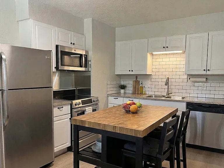 Dine-in island with storage, stainless appliances, new pull-down faucet & microwave. Freshly painted!