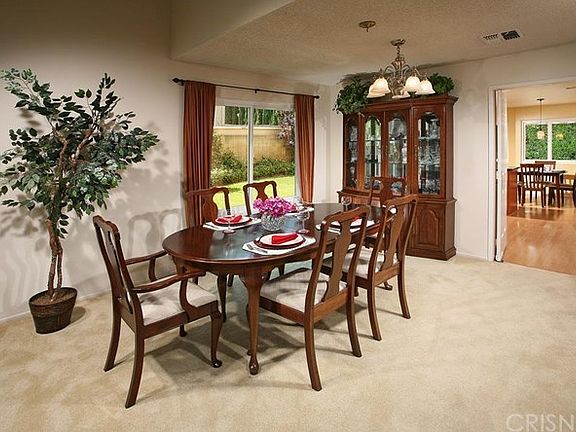 The elegant formal dining room has an adjacent cus