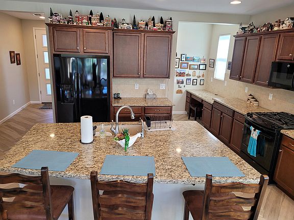 Spacious kitchen with work station and walk-in pantry. Open to the living and dining areas.