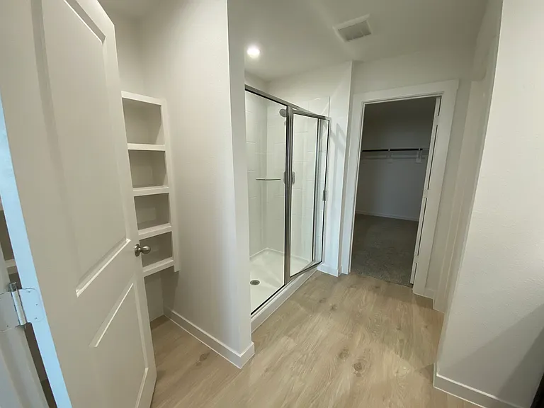 Master bathroom with large shower, additional storage space on the left