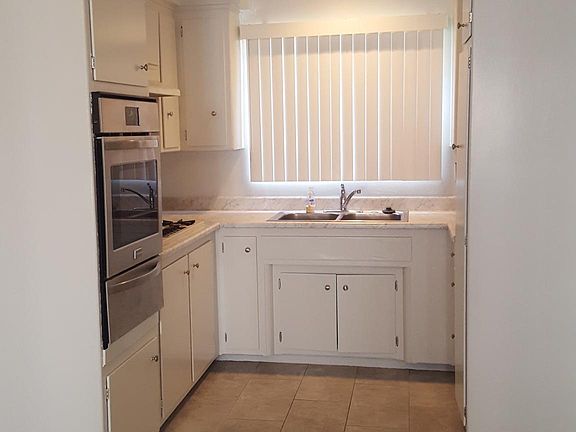 Kitchen with many cabinets and large cabinet for broom, mop, vacuum cleaner, etc.