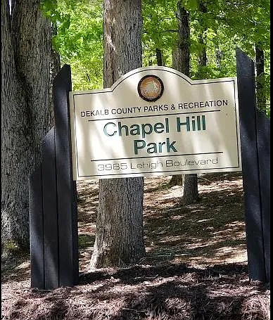 Nearby neighborhood park with mature trees and shaded walking areas, offering convenient outdoor recreation close to home.