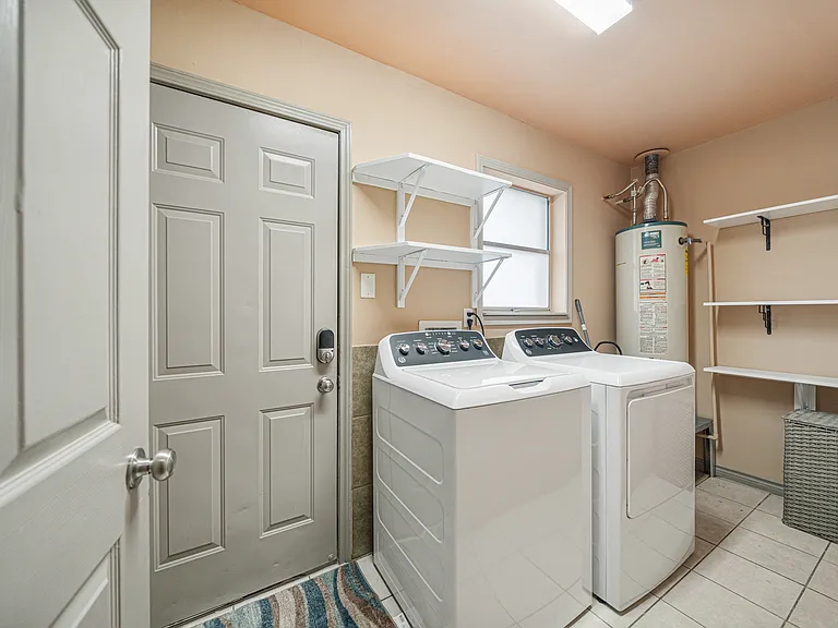 Laundry room with additional space for storage.