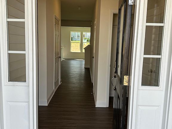 Warm and welcoming front entry with a drop zone and coat closet.
