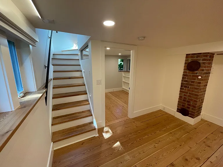 Staircase from kitchen leading into the media room. View into the office.