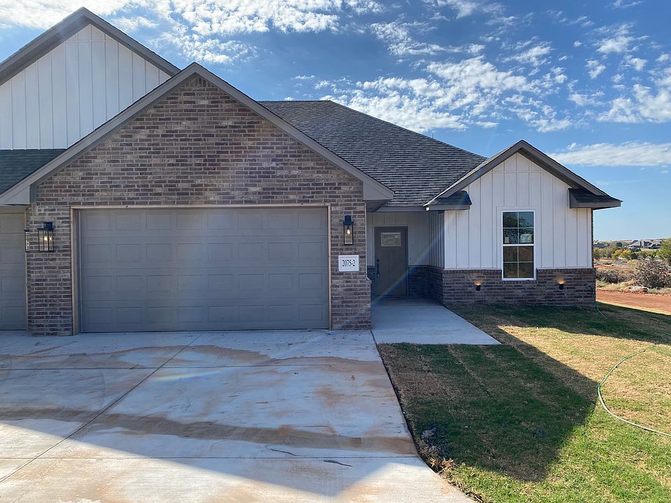 Front of unit with 2 car garage.
