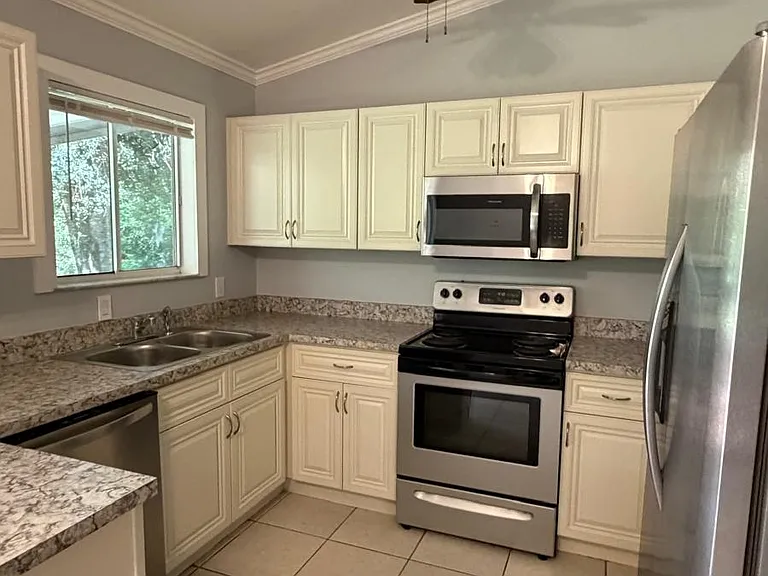 Kitchen with stainless steel appliances including dishwasher