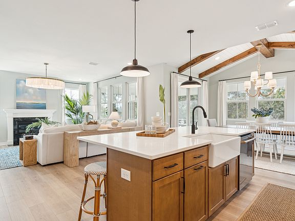 Dining area with stained ceiling beams vaulted ceiling