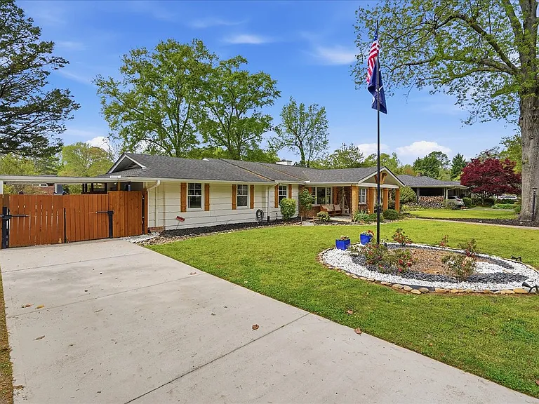 Home features an extra large driveway carport.