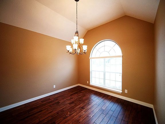 Formal dining room features dark hardwood flooring.