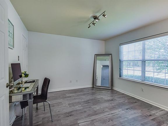The fabulous flooring continues through to the study. Updated lighting and nice large window.
