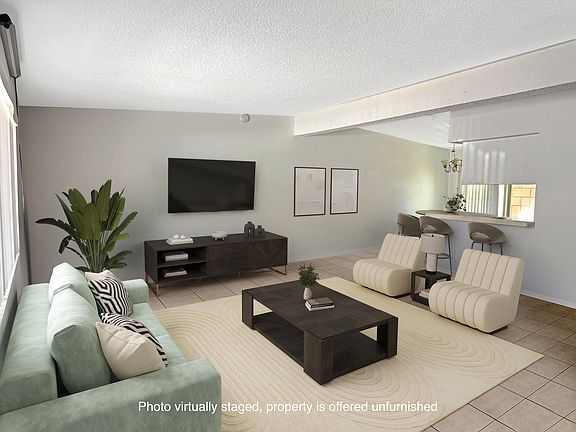 Living room and dining area beyond