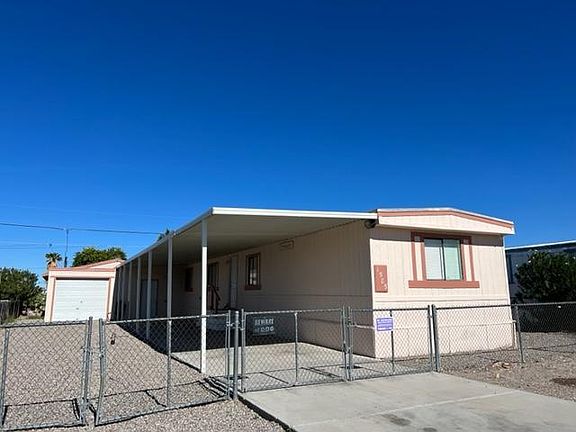Carport with single car garage and two double gates