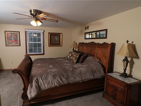Generous 16'x14' bedroom easily holds king sized furniture.  New wood blinds adorn most windows.