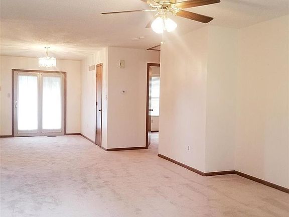 Main level living room open to the breakfast room with entry to the deck. Kitchen is to the left, bedrooms and baths to the righ