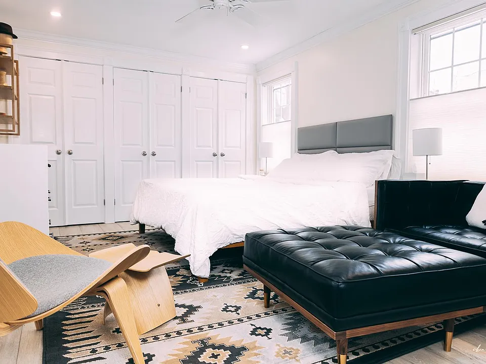 The master bedroom has a king-sized bed and six closets plus a dresser for storage.