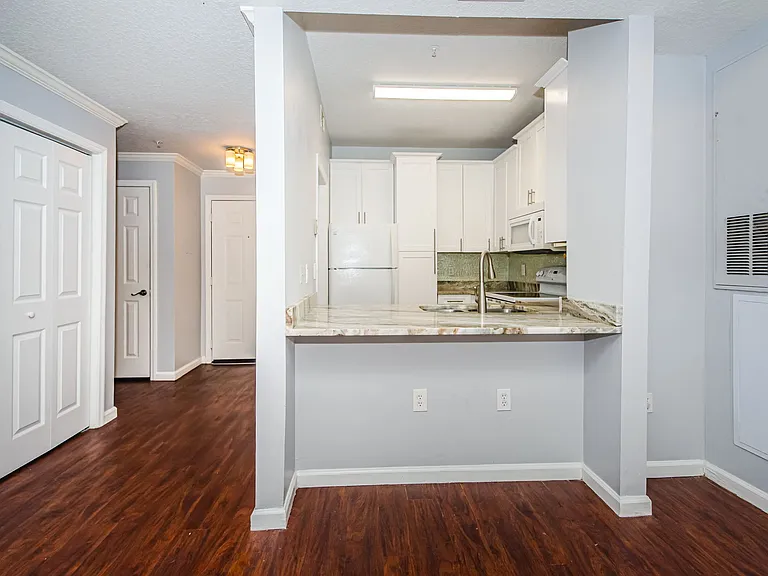 photo towards kitchen showing breakfast bar