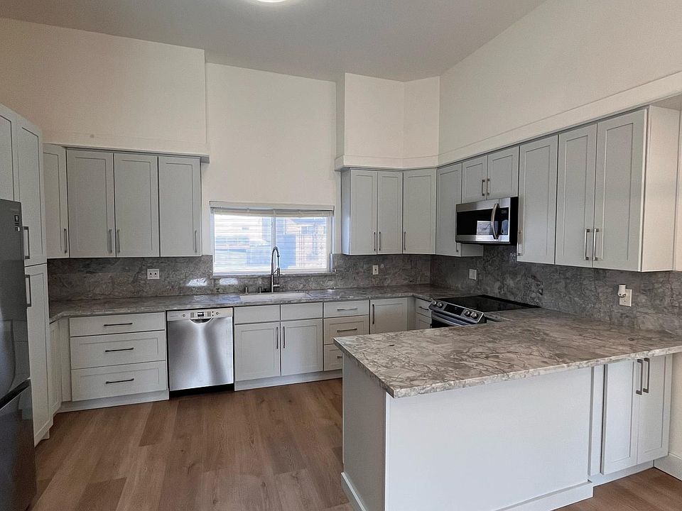 Great open floor plan kitchen with newer appliances. Built in microwave and high end washer/ dryer on by the stainless steal refrigerator.
