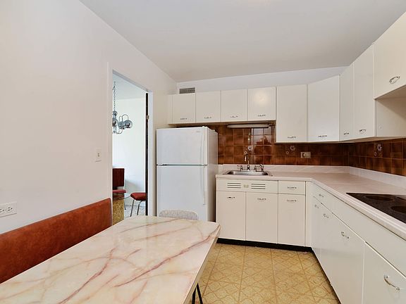 Eat in kitchen with a cute built in banquette.