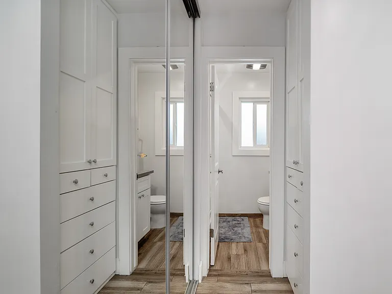 Unit 9 studio hall with built in drawers & cabinets with bathroom entrance