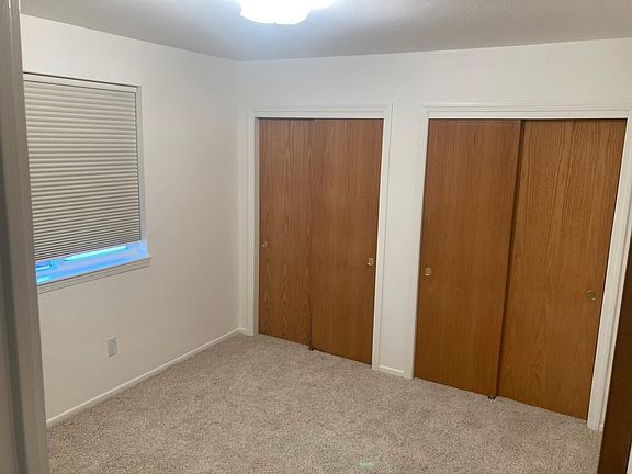 1st bedroom, downstairs, with 2 closets and a window that overlooks the backyard.