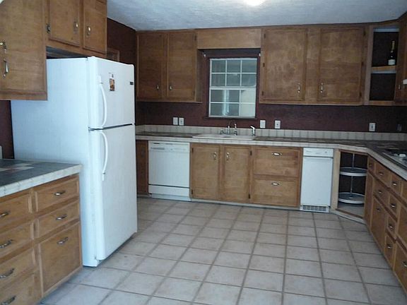 The Kitchen Has Tons of Cabinets, Tile Floors, Tile Countertops, and 5 Burner Cooktop